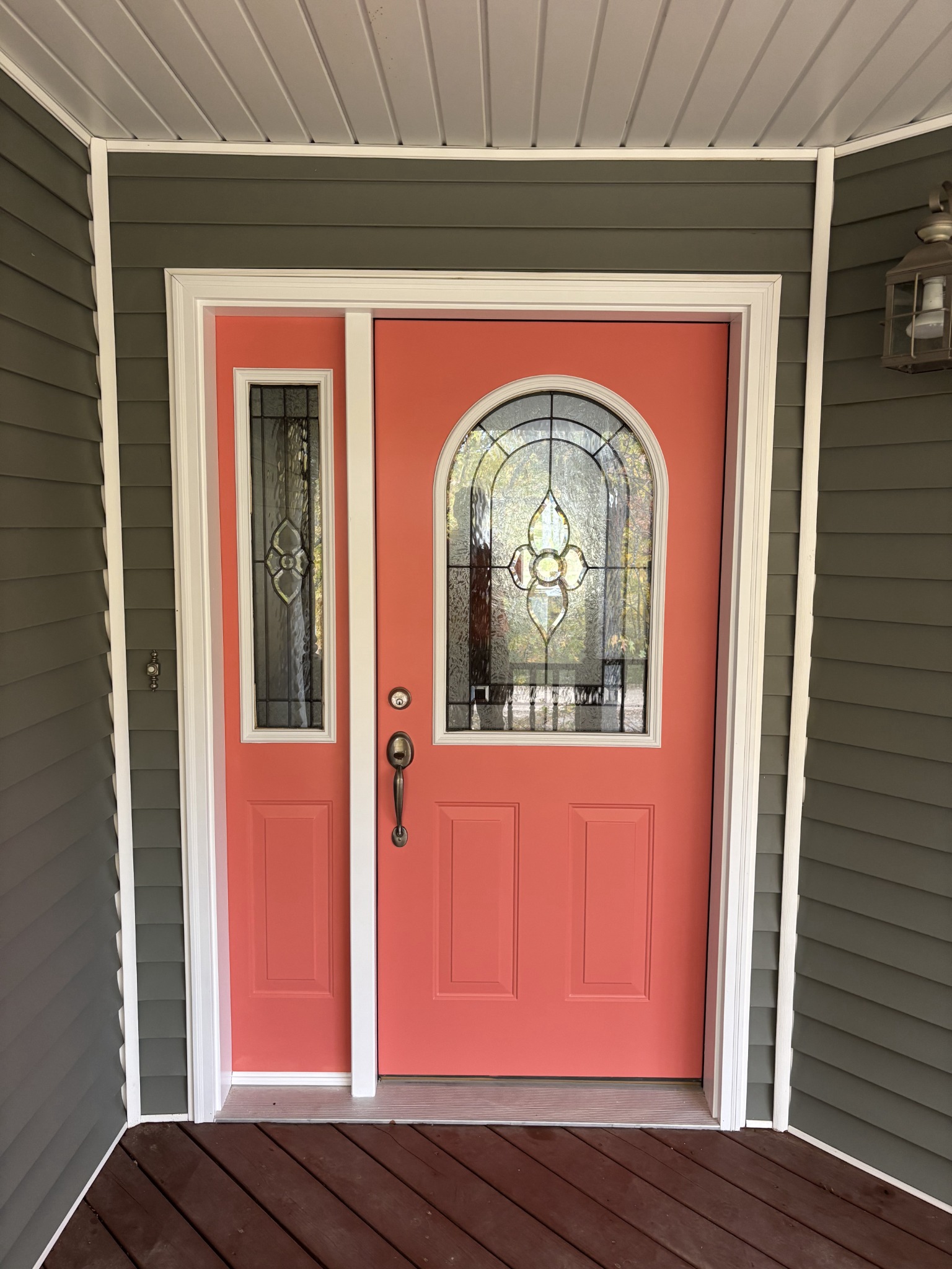 Finished coral front door with bright white trim