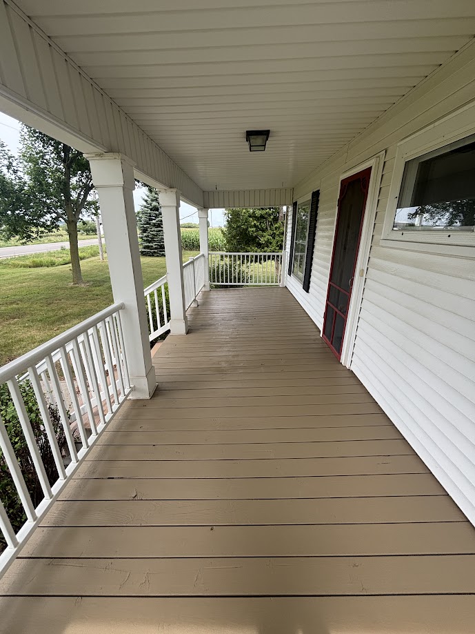 Finished tan porch floor with white railings